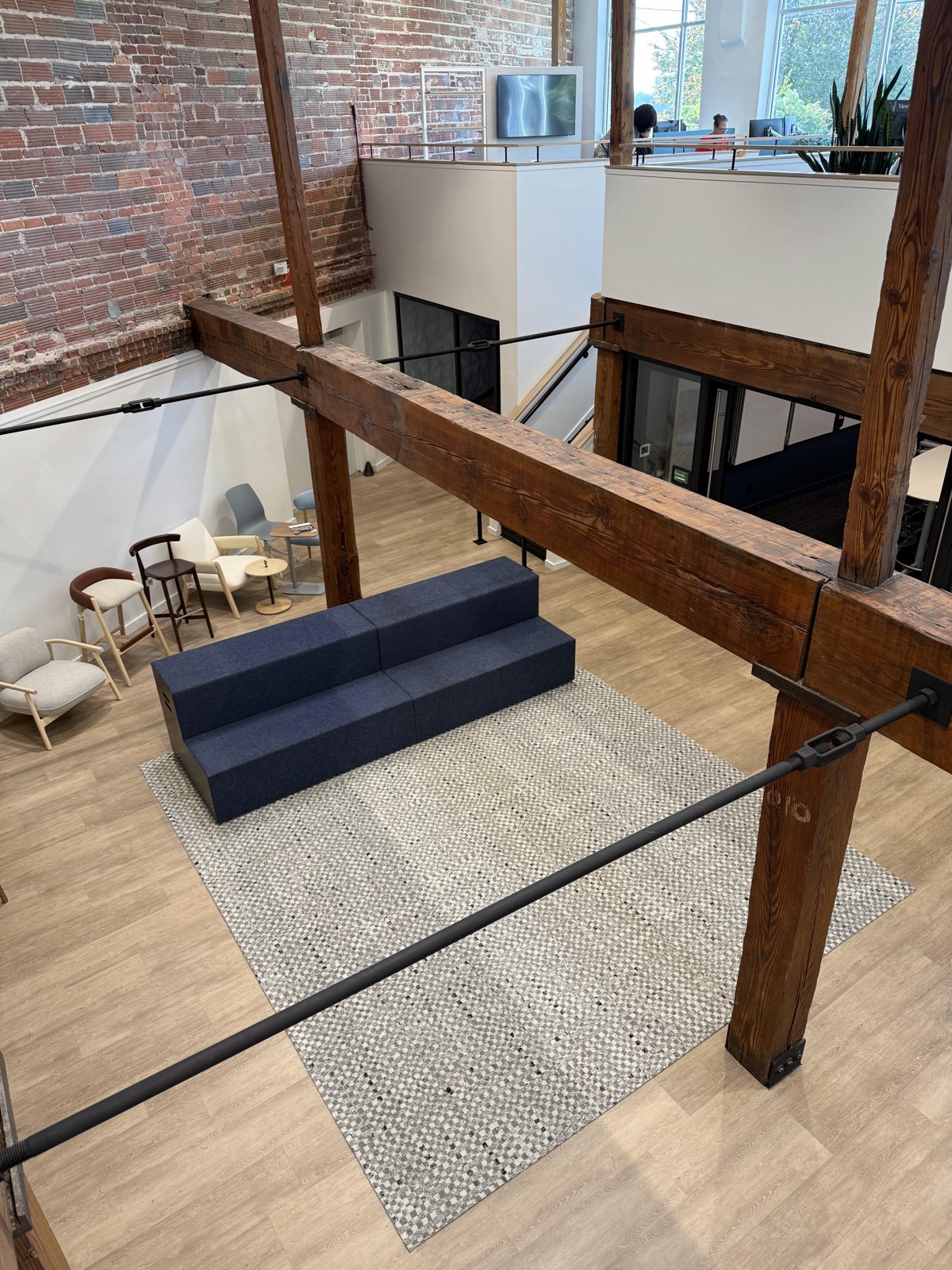 Plank flooring and custom rug in historic showroom